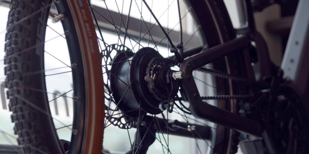 Close-up of the rear tire and braking system on a DAMAXED e-bike.