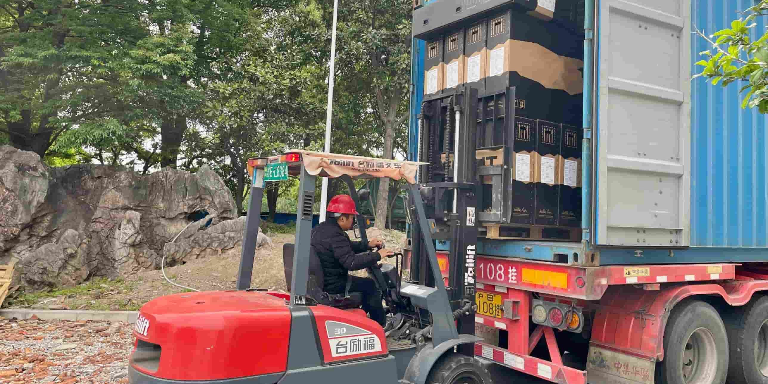 Workers at DAMAXED factory driving forklifts to load customized e-bikes for shipment.