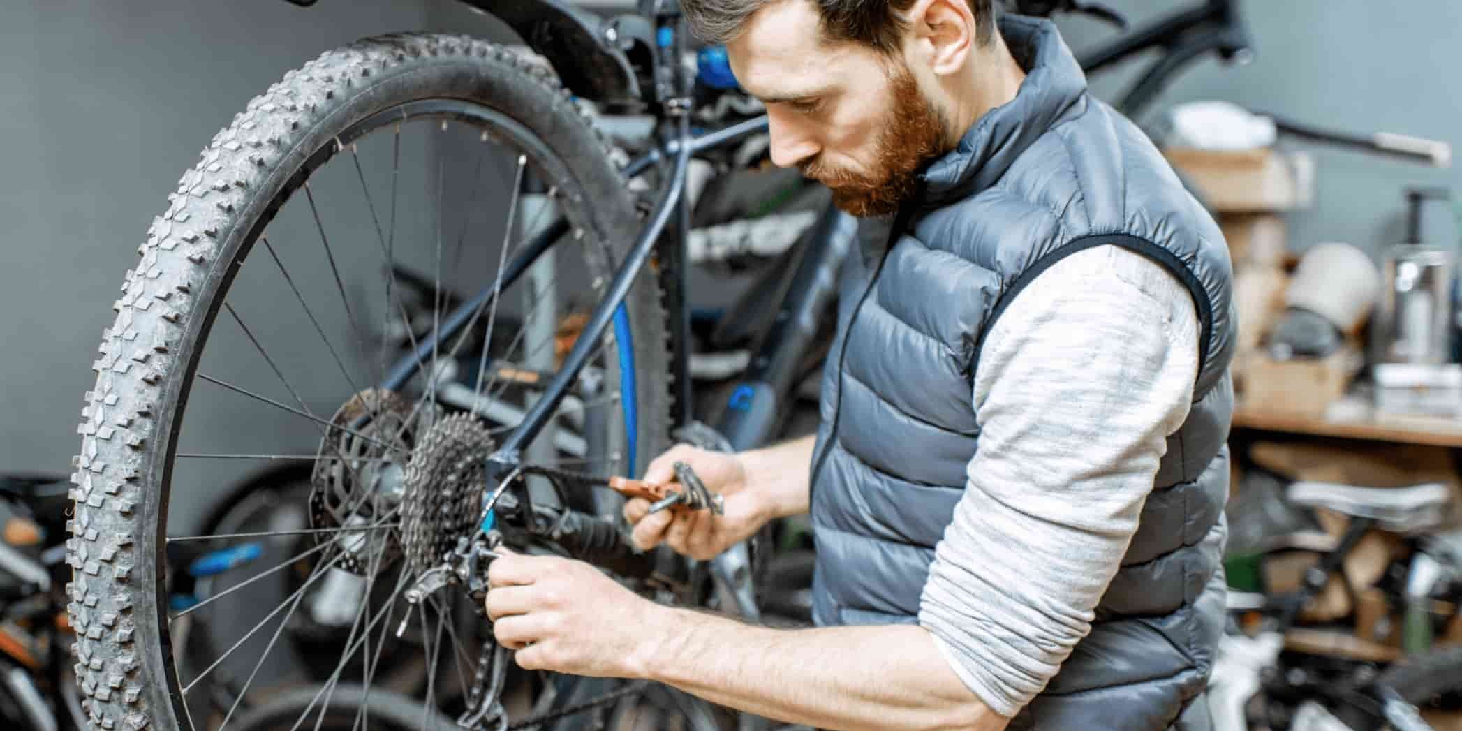 Engineer inspecting electric bicycle spare parts in DAMAXED factory operation room.