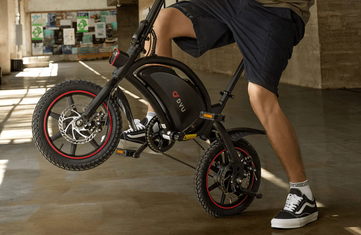 Person using a small dyu d3f foldable electric bike in an indoor setting