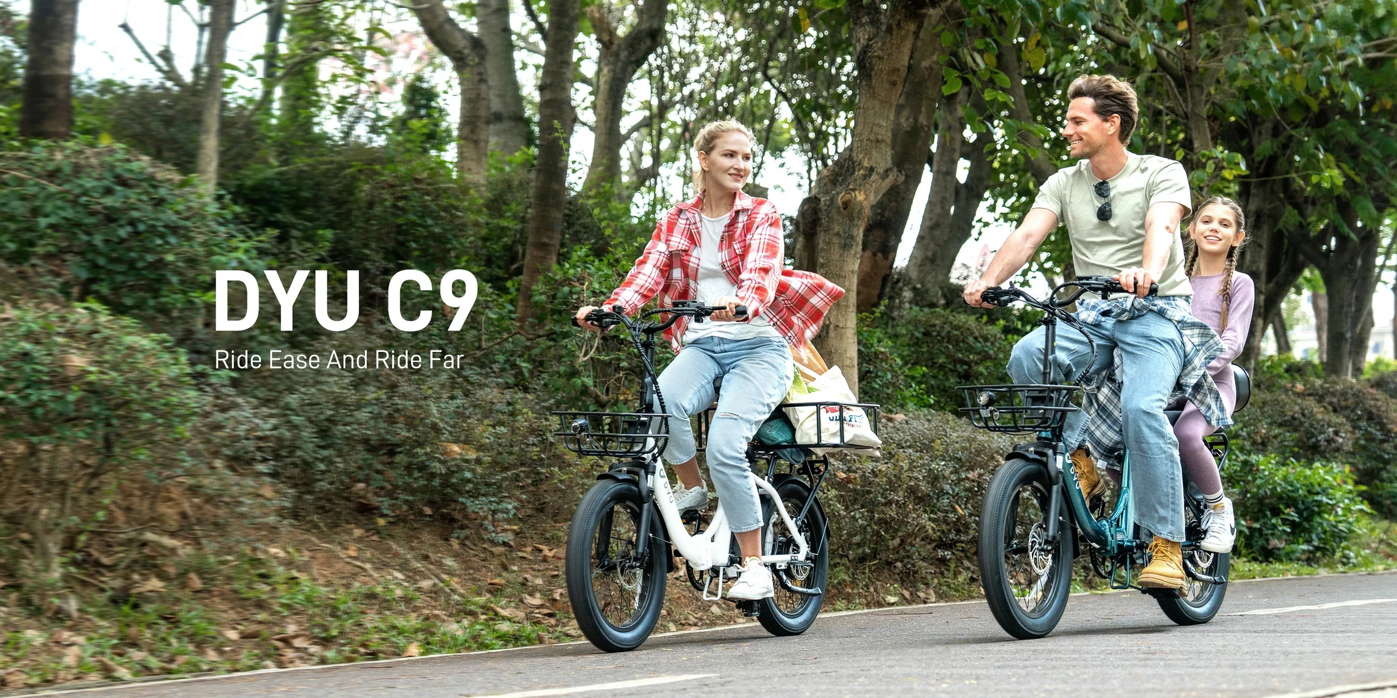 Two people riding DYU C9 electric bikes on a path with trees in the background.