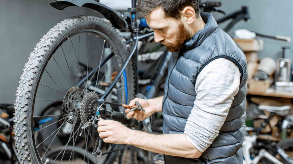 Engineer inspecting electric bicycle spare parts in DAMAXED factory operation room.