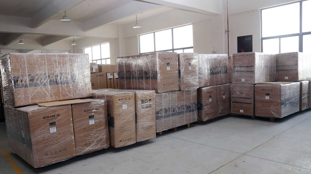 Neatly placed in DAMAXED factory warehouse corner, packed e-bikes await transportation.