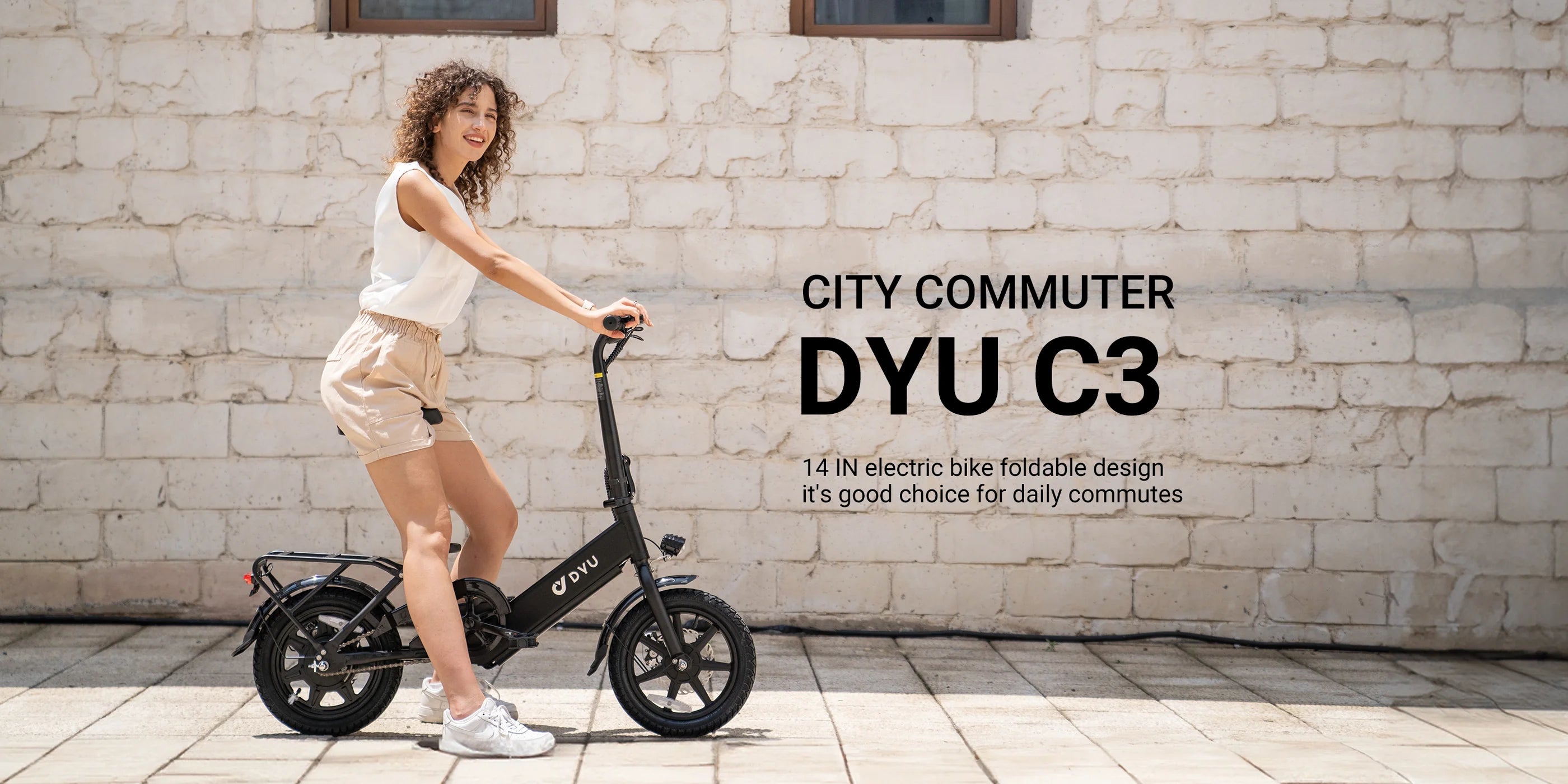 Woman riding a City Commuter DYU C3 electric bike against a brick wall.